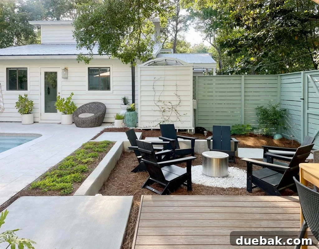 Inviting sunken firepit area next to a sparkling pool in a minimalist backyard