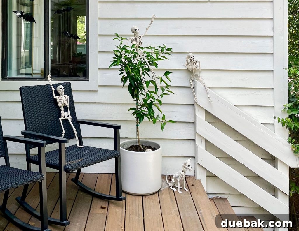Playful skeletons posed in various positions on a front porch for Halloween