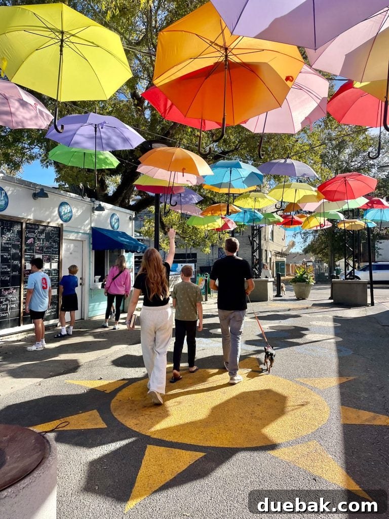 Kids Walking Under Bright Umbrellas In Cash Alley In Ocean Springs Mississippi
