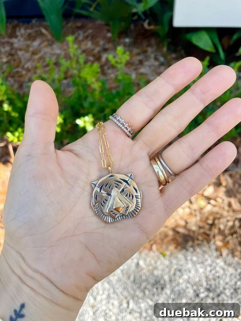 Sherry Hand Holding Gold Tiger Necklace Purchased at Palmette In Ocean Springs Mississippi