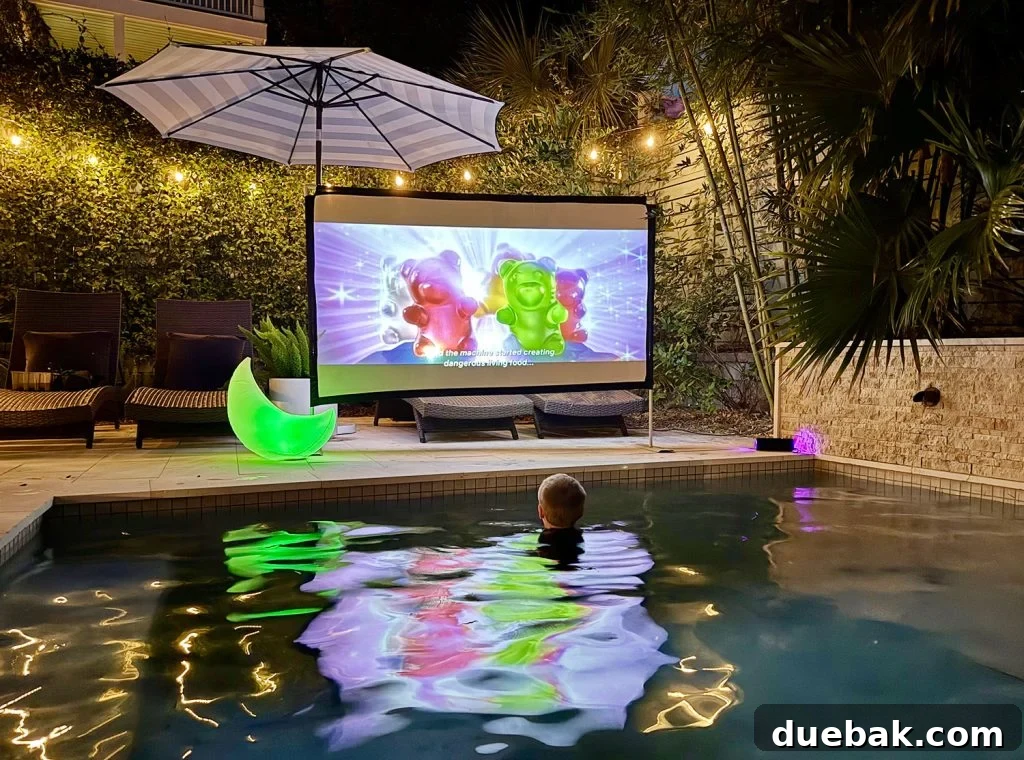 Outdoor Movie Night In Pool With Projector And Screen - A family enjoys an evening movie from their swimming pool with a large projection screen.