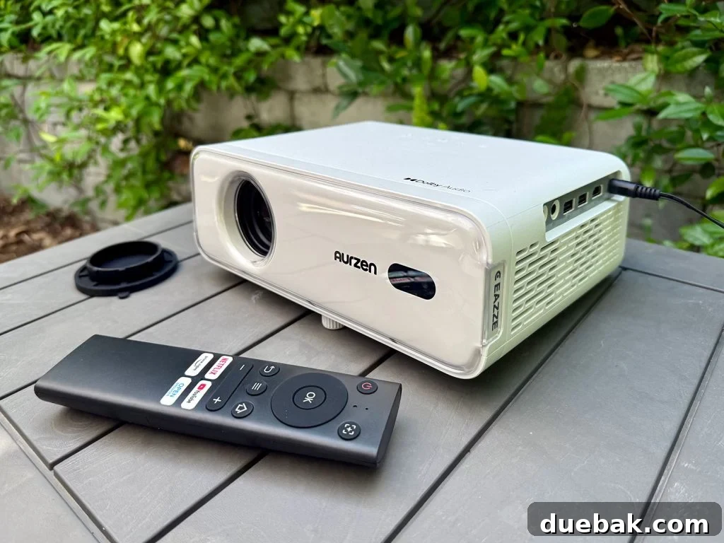 Aurzen Smart Projector With Remote and Wifi - A compact, modern projector with remote control for easy outdoor use.