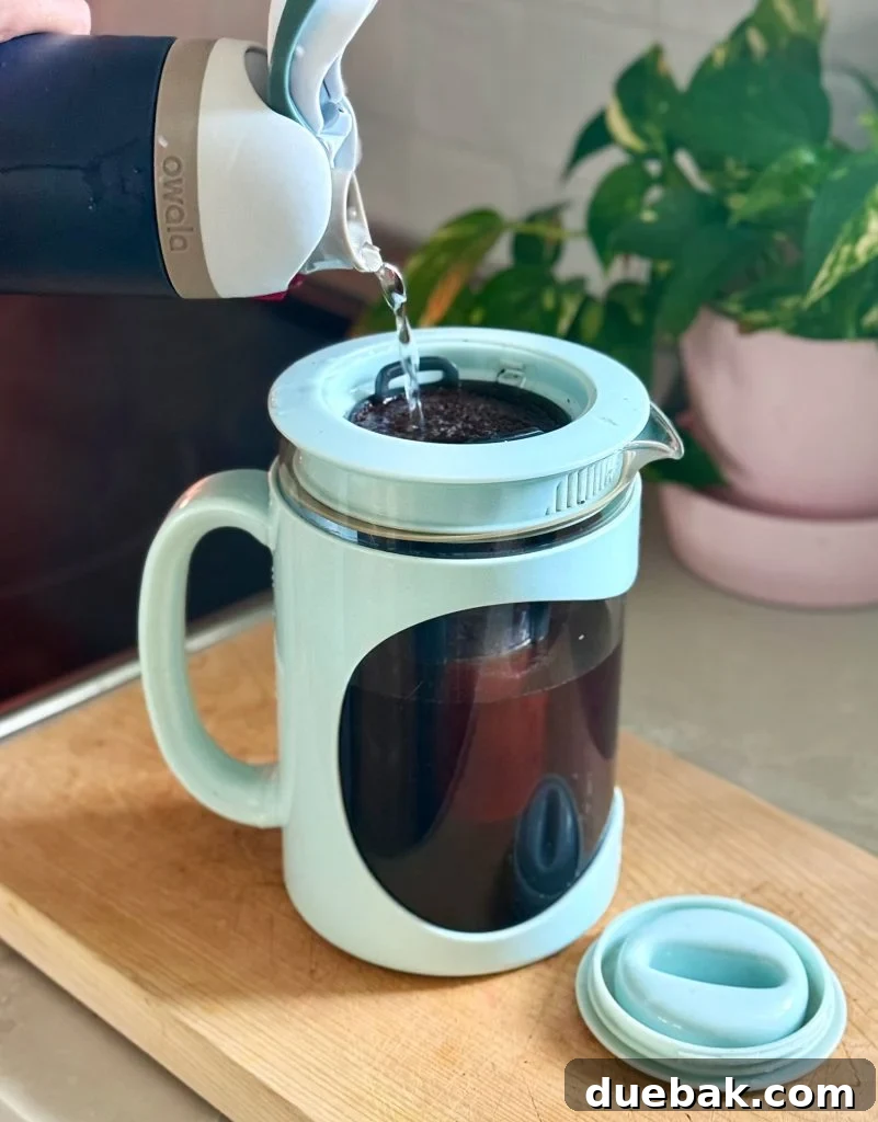 Brew Your Own Perfect Cold Brew 8 Adding Water Over Coffee Grounds In Home Cold Brew Maker