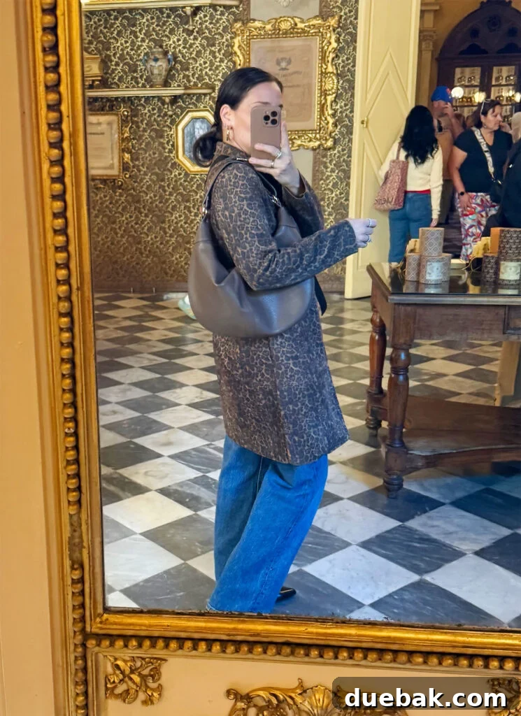 Travel Light to Italy My Ultimate Packing Secrets 16 Sherry Selfie In Mirror With Leopard Coat And Jeans In Florence Italty - New Leather Purse