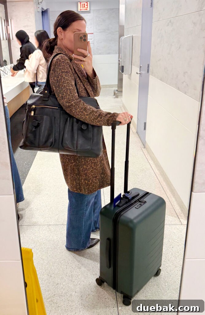 Travel Light to Italy My Ultimate Packing Secrets 3 Sherry Selfie In Airport Mirror With Suitcase On Trip To Italy - Italian Fashion