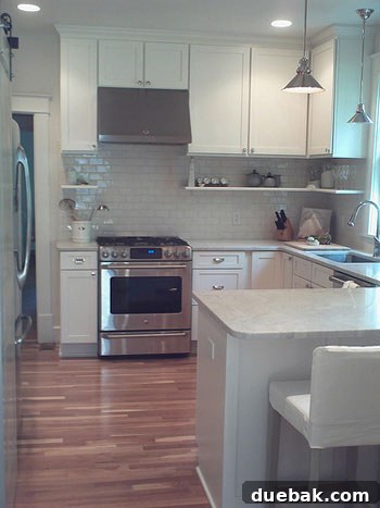 Crisp White Kitchen: Subway Tile Delivers Timeless Style 3 Rachel's newly renovated kitchen showcasing bright white shaker cabinets, sleek new appliances, and an open, airy design that maximizes natural light.