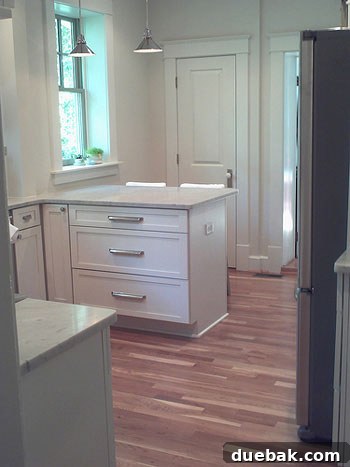 Crisp White Kitchen: Subway Tile Delivers Timeless Style 4 A close-up of the elegant white marble countertops in Rachel's kitchen, revealing subtle grey veining and the smooth, luxurious surface that defines the space.