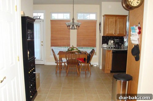 before photo of kitchen breakfast nook with dark blinds covering windows