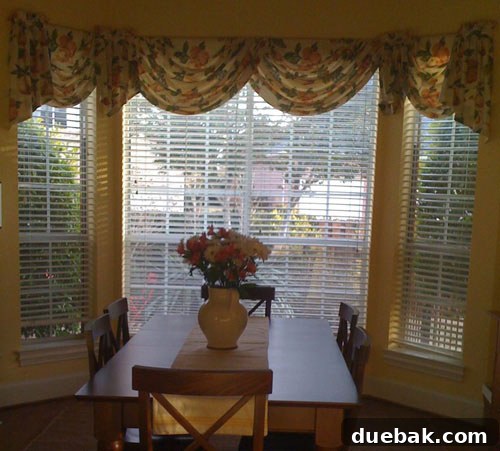 dated bay window in kitchen breakfast nook with floral window valance