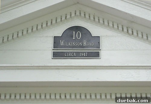 Stunning Richmond Transformation 14 Close-up of the front door with meticulously restored dentil molding and a custom architectural plaque, emphasizing the home's historic details and curb appeal.