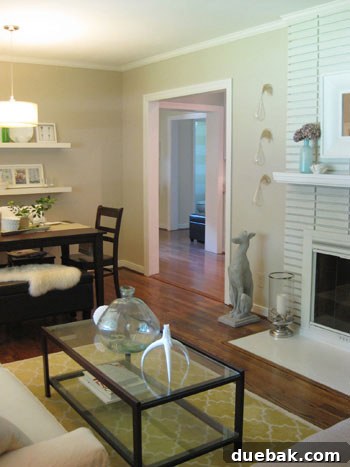 Elegant cream on cream striped wall in an open living room dining room bathroom view