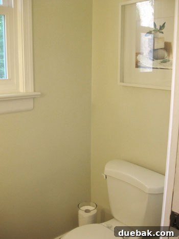Before shot of a plain half bathroom wall awaiting a stripe painting tutorial