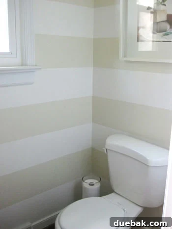 Finished bathroom horizontal stripe paint project revealing clean lines