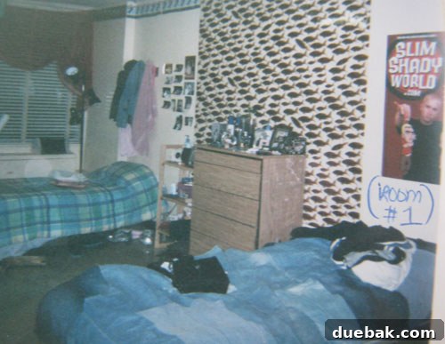A student dorm room featuring denim bedding and a fish shower curtain used as a wall mural.