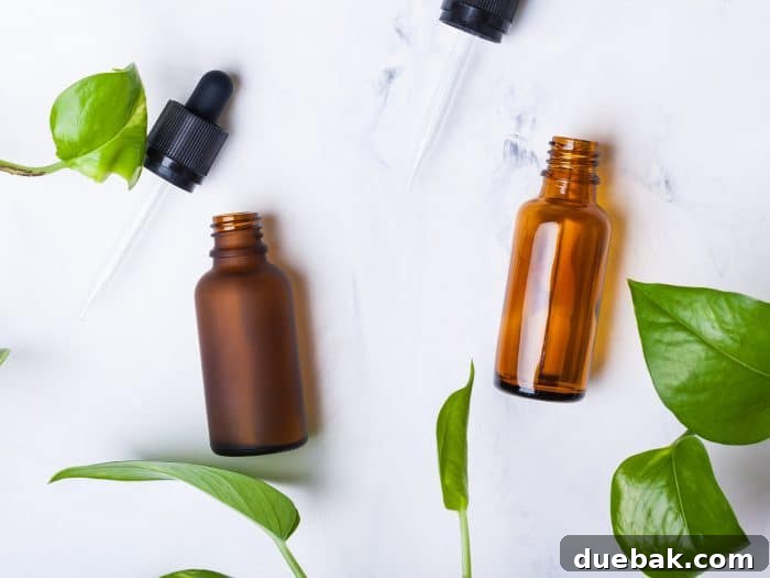 Glass bottles for natural cosmetics on a white marble background