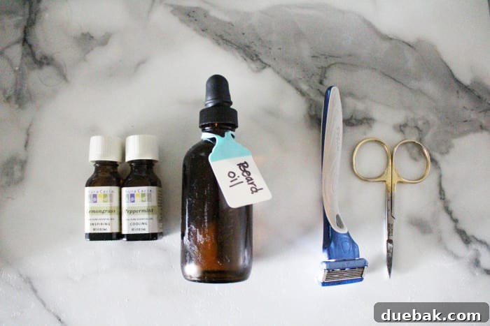home made beard oil bottle with essential oils, a razor, and scissors.