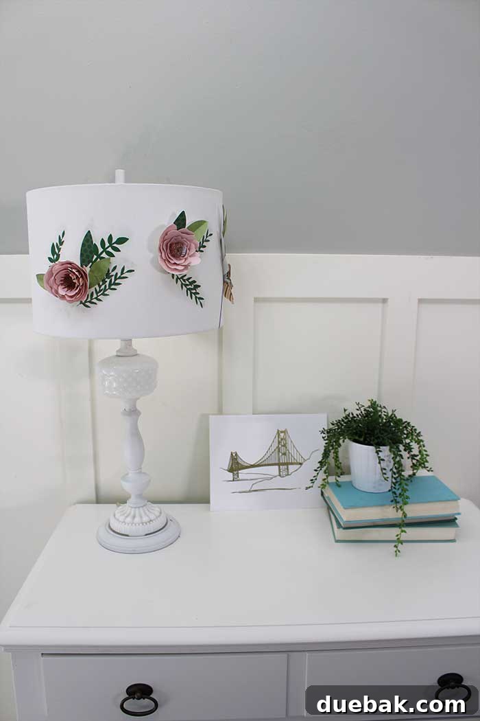 Detailed process of assembling paper flowers with hot glue for a DIY lampshade project