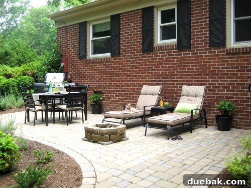 Designing Our First Home's Curb Appeal 12 View of the back of the house and patio from the cobblestone path near the gate.