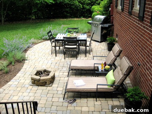 Designing Our First Home's Curb Appeal 5 View of the outdoor patio area from the sunroom steps, showing seating and decor.