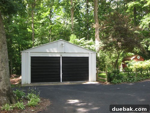 Designing Our First Home's Curb Appeal 8 The newly painted black garage door in the backyard setting on a typical day.