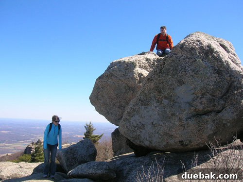 John's cousin and sister hiking on a rocky mountain trail.