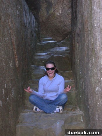 Sherry struggling to climb over large rocks during the challenging Old Rag Mountain hike.