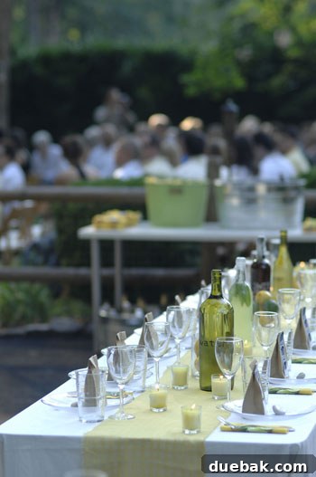 Assorted glass bottles, hand-labeled and filled with various beverages like water, sweet tea, and homemade mint lemonade, showcasing a chic, DIY wedding drink station setup.
