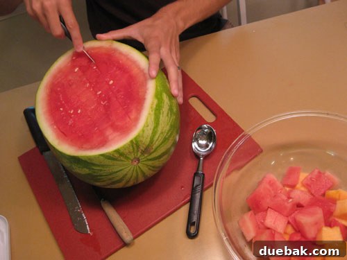 John making criss-cross cuts in a watermelon