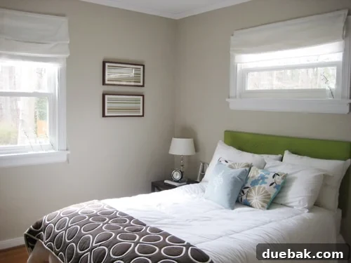 Build a Beautiful, Lightweight Fabric Headboard 2 Green upholstered headboard in a guest bedroom, showcasing a simple DIY project.