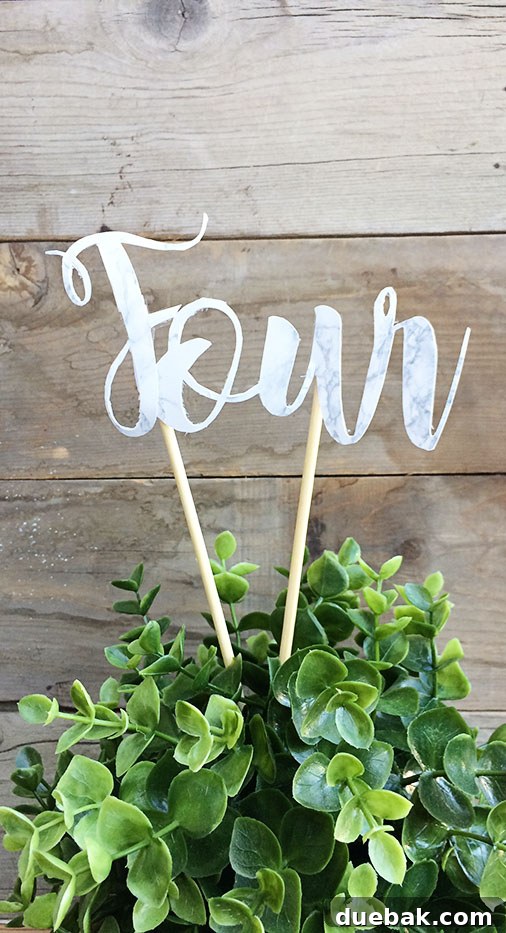 Assembling DIY wedding table numbers with skewers