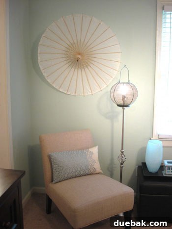 Final corner with parasol art and a birdcage lamp
