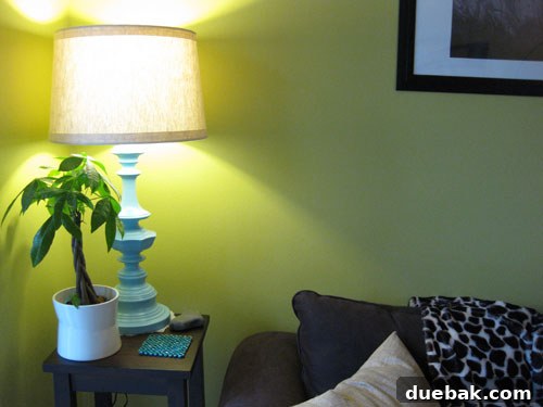 Laura's completed lamp makeover, showcasing it in a styled home setting, glowing beautifully.