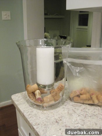 The Secret to Straight Candlesticks 6 Close-up of wine corks filling a hurricane vase around an elevated pillar candle, creating a full centerpiece