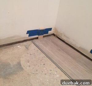 Transform Your Space with Vinyl Plank Flooring 11 Laying out the first row of vinyl planks