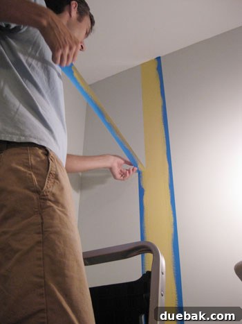 Crafting Your Perfect Nursery 5 Painting various accent colors within the taped sections of the nursery wall