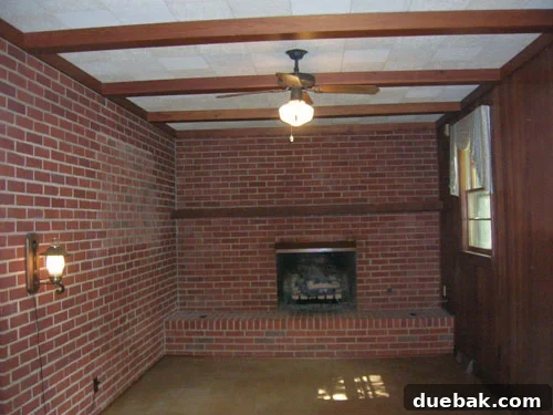 Transform Wood Paneling with Paint for a Modern Look 3 Before painting dark wood paneling in a cozy den, showing an outdated look