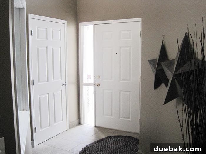 Elevate Your Entryway: Mastering Front Door Installation 4 Interior view of entryway with dark paint and board and batten paneling.