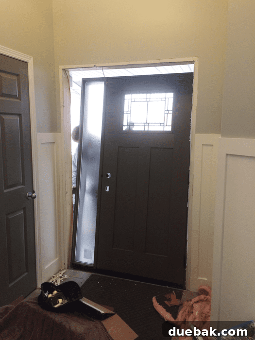Elevate Your Entryway: Mastering Front Door Installation 10 Professional door installation in progress, focusing on securing the new door.