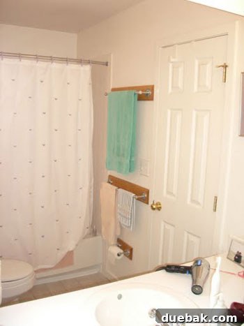 Teal Tranquility: Bathroom Revamp 2 Before image of a bland, builder-grade bathroom with standard vanity and fixtures