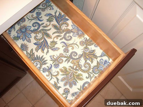 Teal Tranquility: Bathroom Revamp 4 Close-up of the elegant dark painted vanity with decorative drawer liners and new hardware
