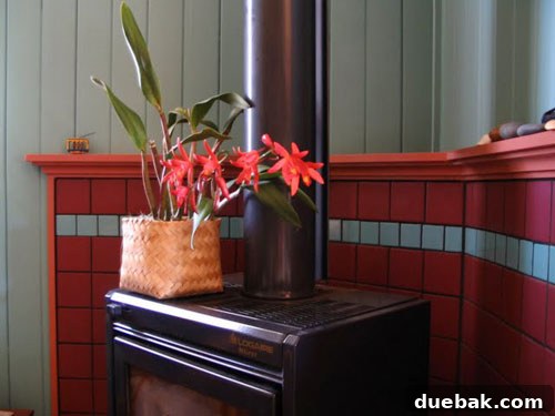 Panoramic view of the cheerful teal and red living room makeover, illustrating how a small cottage can achieve big style with vibrant color choices.