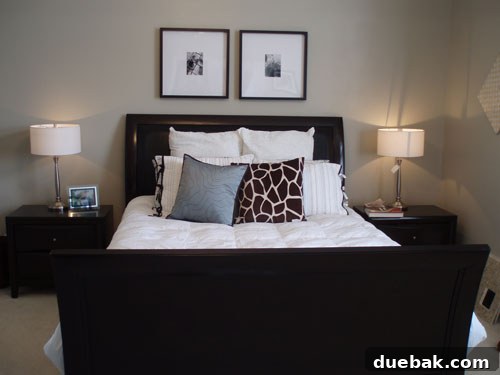A bedroom with plain, light-colored walls before a striped paint transformation.