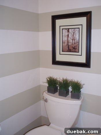 A bathroom wall painted with stylish, contemporary stripes, adding visual interest.