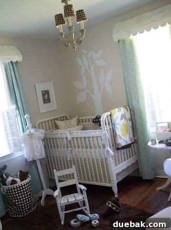 Blush Nursery Bliss 3 Modern cottage style nursery with blue and white decor, crib, and comfortable rocking chair