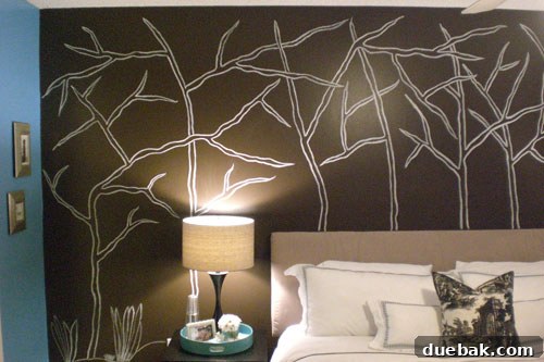 After the bedroom makeover: a stunning hand-painted forest wall mural creating a serene ambiance.