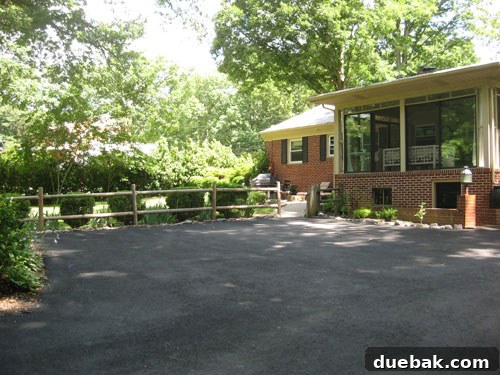 Old photo showing the exterior of the house with a screened-in sunroom, highlighting a major DIY project.