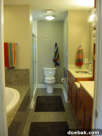 Eco-friendly master bathroom featuring stylish recycled tiles, sustainable wood built-in cabinetry, and a salvaged countertop, combining functionality with responsible design