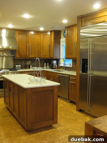 Modern kitchen addition with natural cork flooring, a sparkling recycled glass backsplash, sleek countertops, and energy-efficient appliances, demonstrating sustainable design