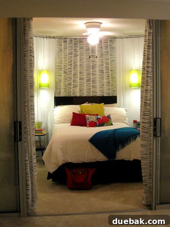 Partial curtain solution behind the bed, showing striped fabric clipped over vertical blinds.