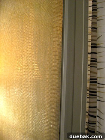 Finished sliding door privacy screen with grasscloth panels, adding texture and privacy.